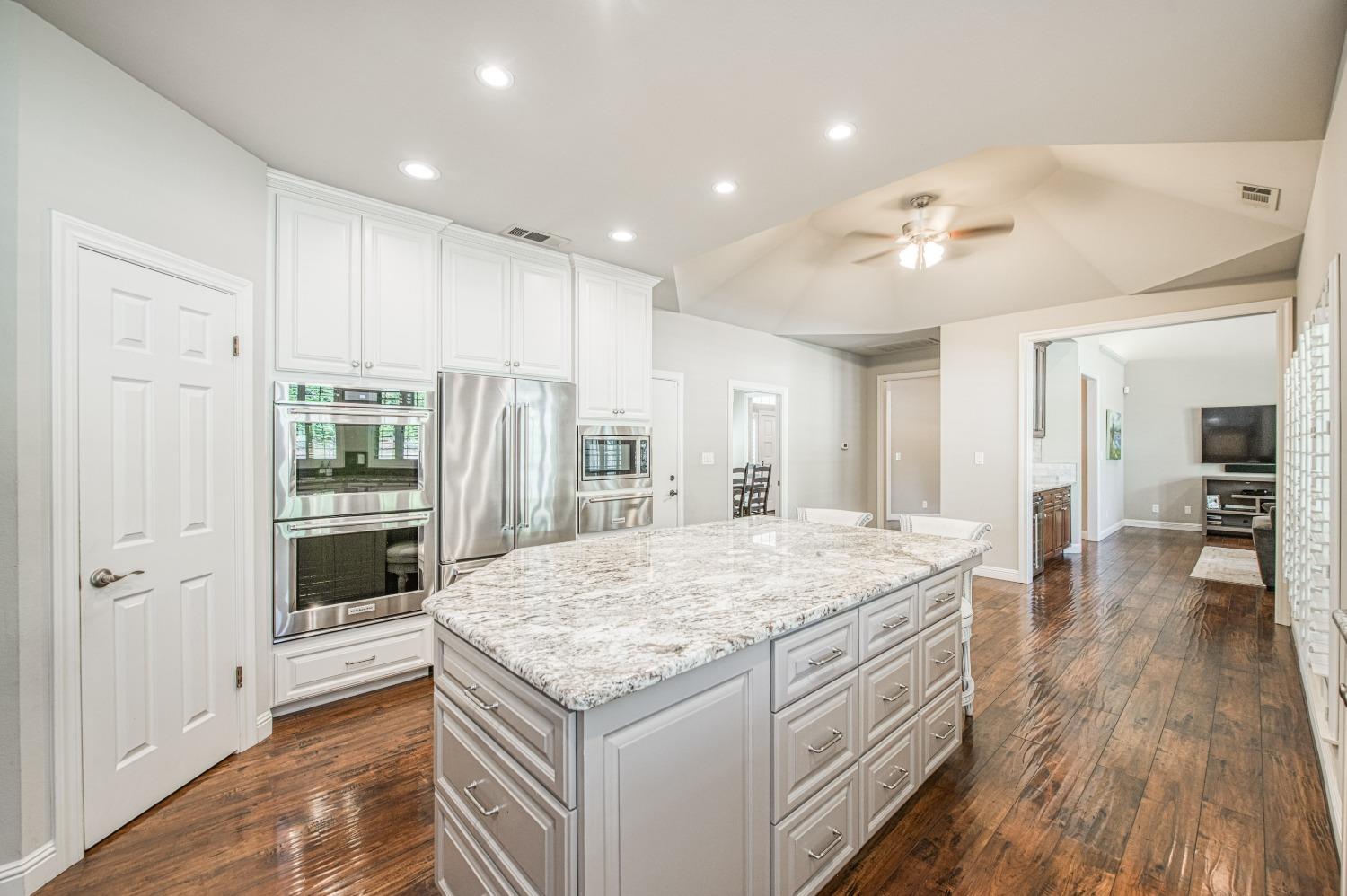 692 East Blue Ridge Road Fresno, CA 93725 - Photo 25 of 68 a kitchen with kitchen island a sink stainless steel appliances and cabinets