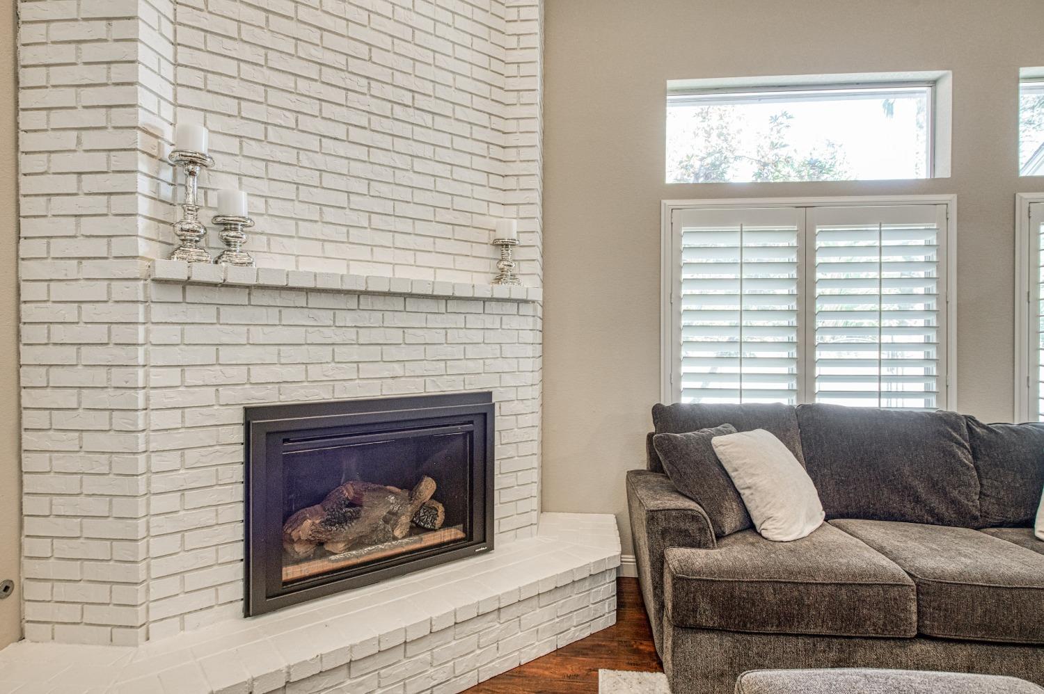 692 East Blue Ridge Road Fresno, CA 93725 - Photo 30 of 68 a living room with furniture and a fireplace