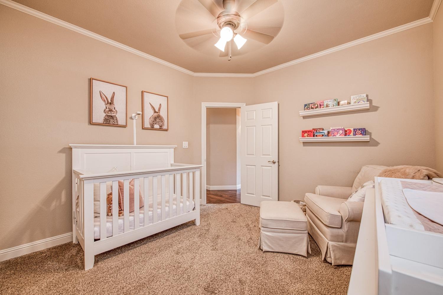 692 East Blue Ridge Road Fresno, CA 93725 - Photo 33 of 68 a living room with furniture and a baby crib