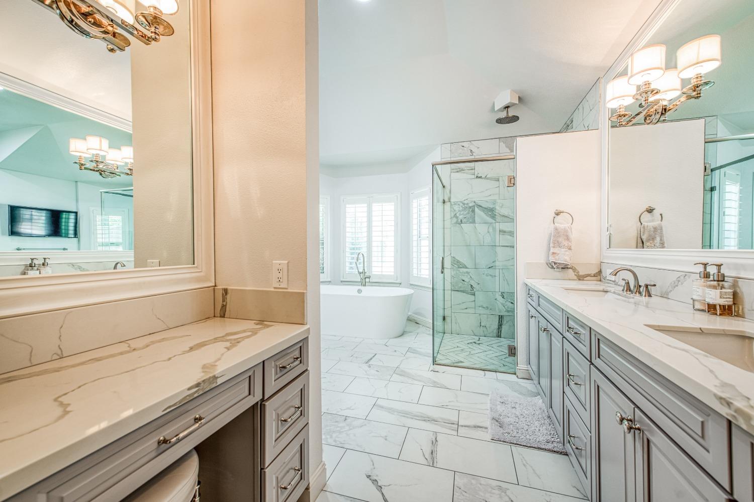 692 East Blue Ridge Road Fresno, CA 93725 - Photo 39 of 68 a spacious bathroom with a granite countertop sink mirror and a