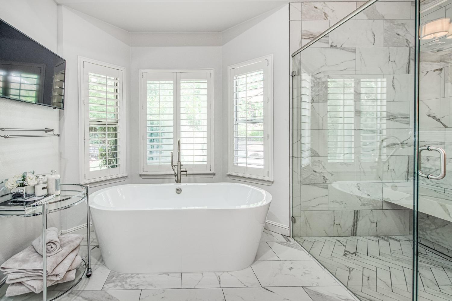 692 East Blue Ridge Road Fresno, CA 93725 - Photo 40 of 68 a white bath tub sitting in a bathroom next to a window