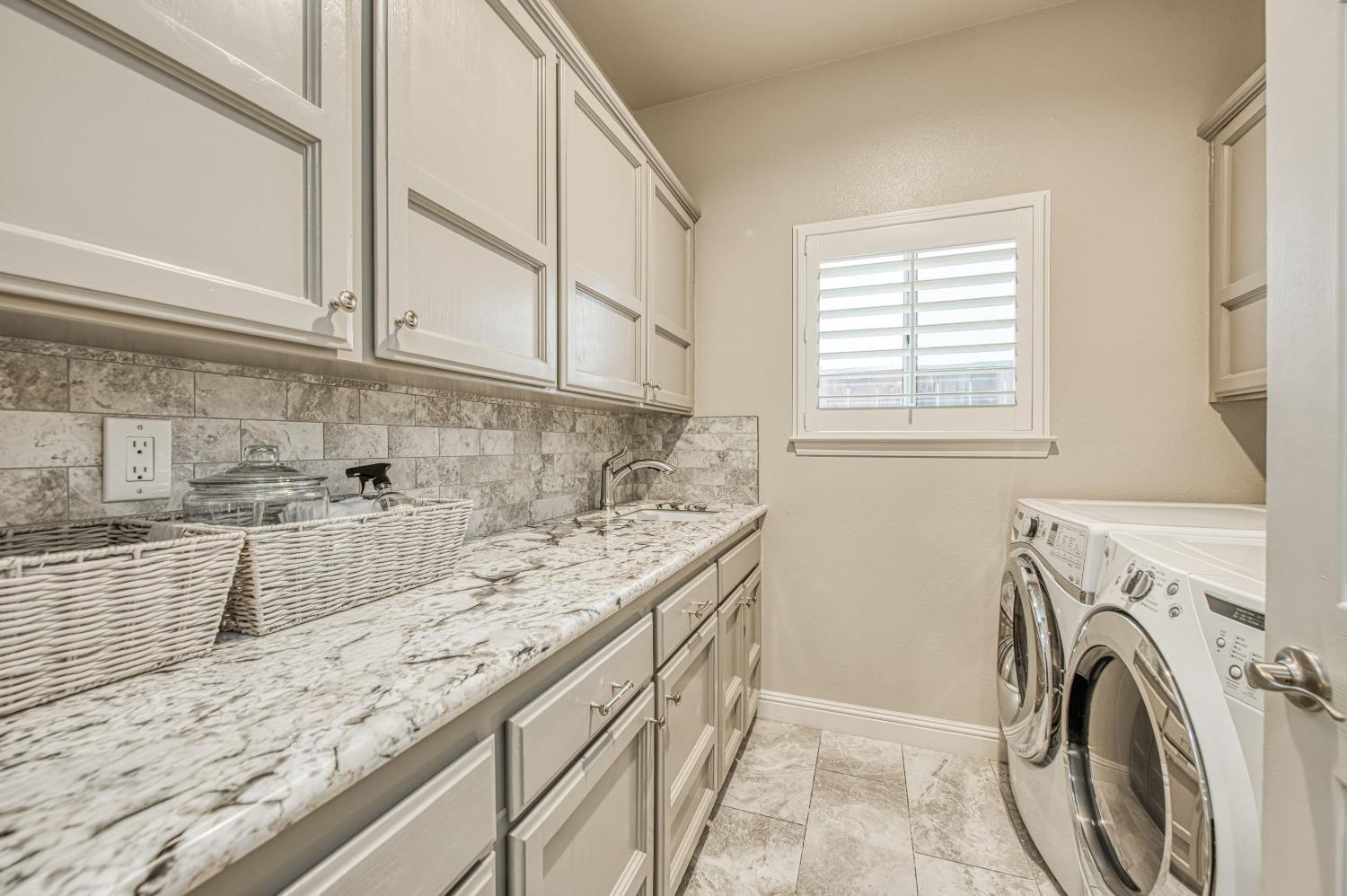 692 East Blue Ridge Road Fresno, CA 93725 - Photo 42 of 68 a view of a kitchen with sink washer and dryer