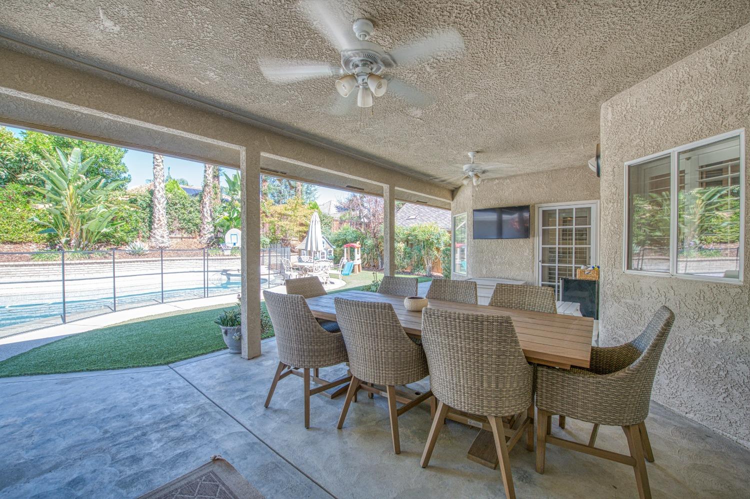 692 East Blue Ridge Road Fresno, CA 93725 - Photo 46 of 68 a dining room with furniture a chandelier and wooden floor