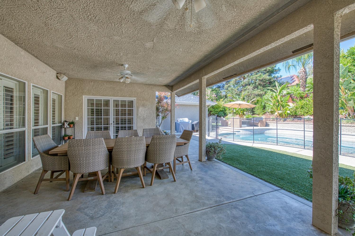 692 East Blue Ridge Road Fresno, CA 93725 - Photo 47 of 68 a view of a patio with table and chairs