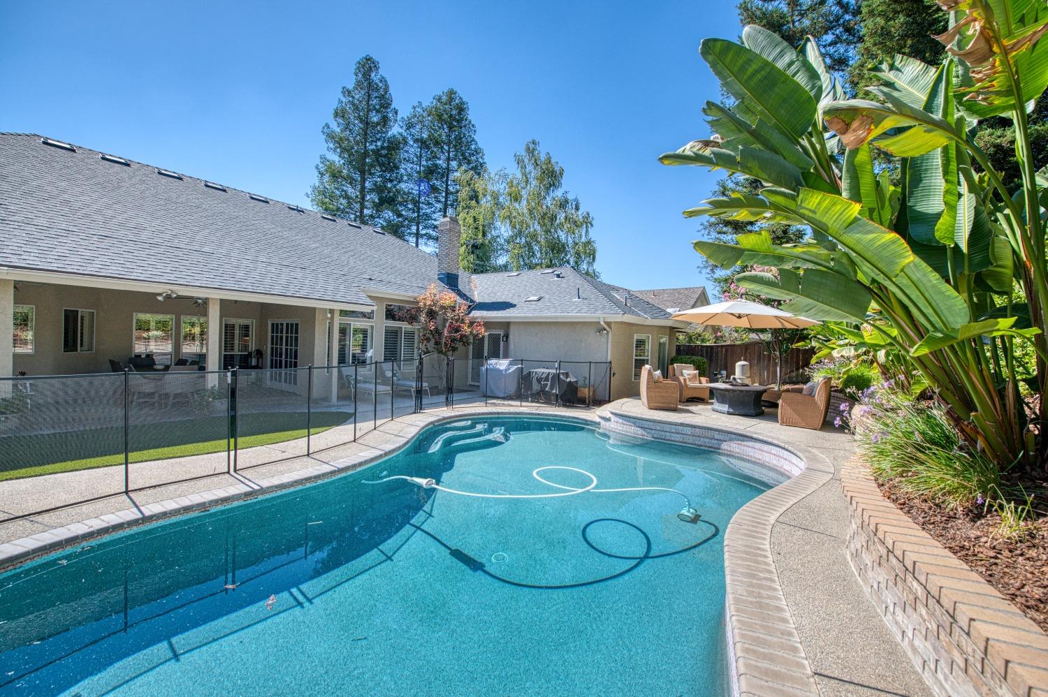 692 East Blue Ridge Road Fresno, CA 93725 - Photo 52 of 68 a view of a house with swimming pool and porch with furniture