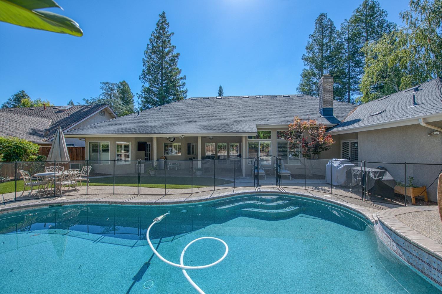 692 East Blue Ridge Road Fresno, CA 93725 - Photo 54 of 68 a backyard of a house with yard table and chairs