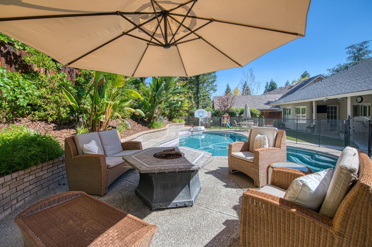 692 East Blue Ridge Road Fresno, CA 93725 - Photo 57 of 68 a view of a patio with couches under an umbrella