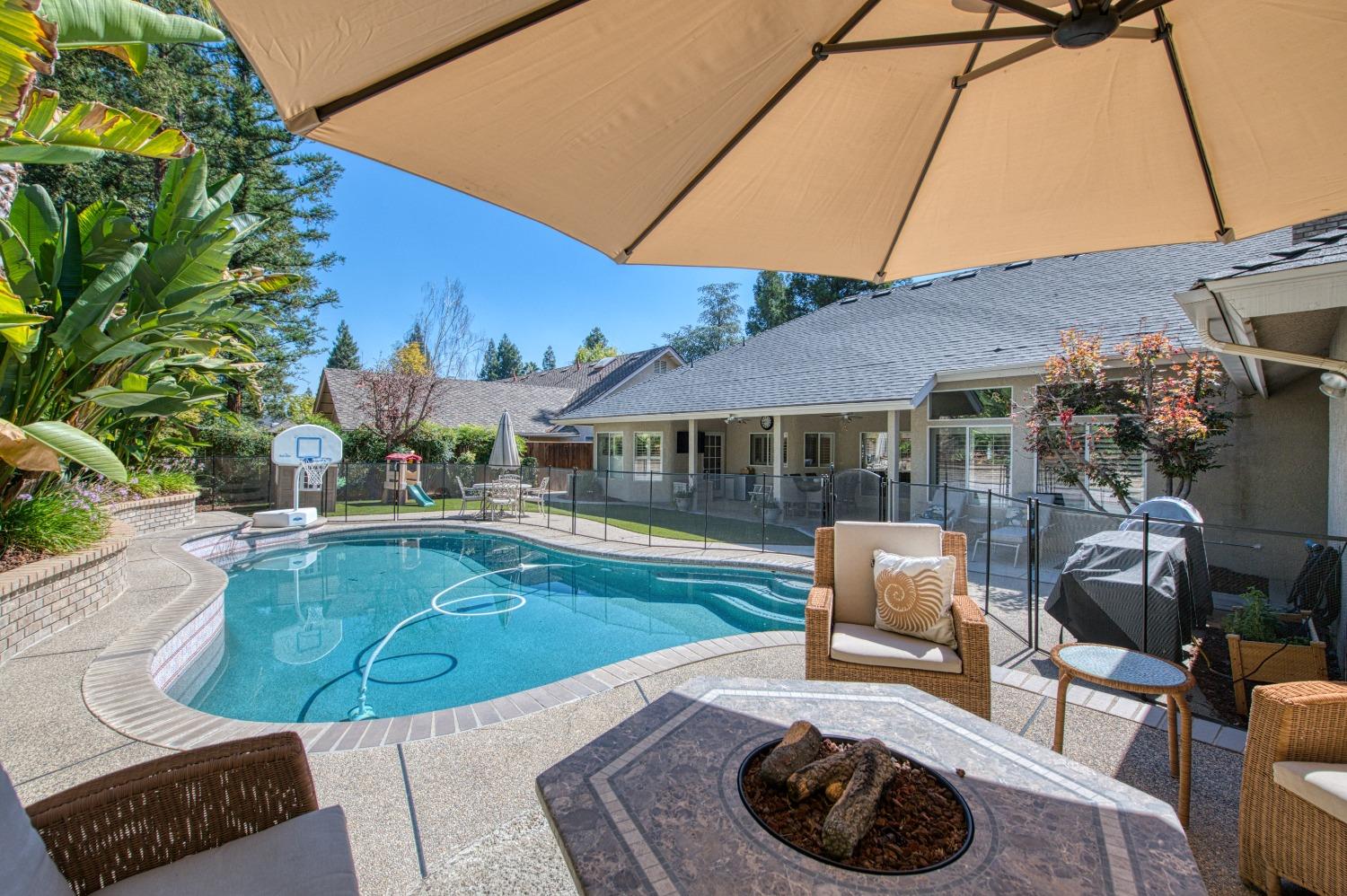 692 East Blue Ridge Road Fresno, CA 93725 - Photo 58 of 68 a view of a house with backyard sitting area and swimming pool