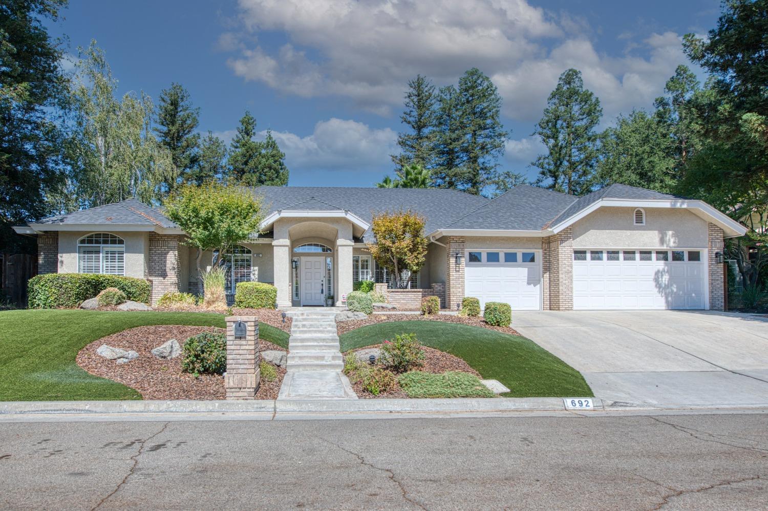692 East Blue Ridge Road Fresno, CA 93725 - Photo 8 of 68 a front view of a house with garden