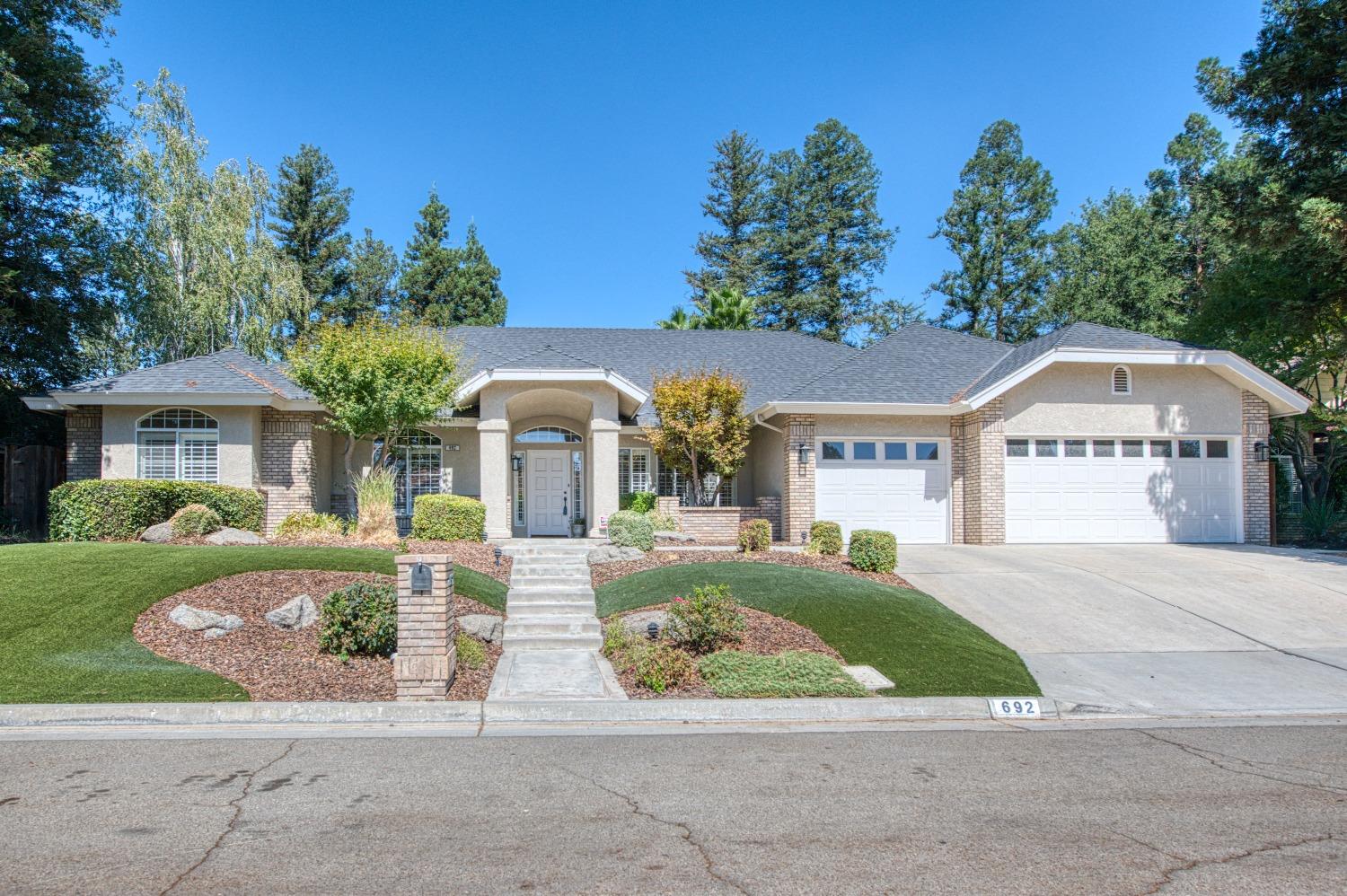 692 East Blue Ridge Road Fresno, CA 93725 - Photo 9 of 68 a front view of a house with garden