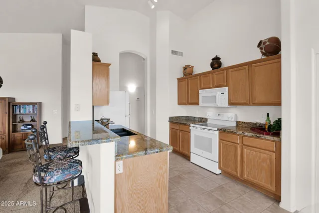 a bathroom with a sink mirror and toilet