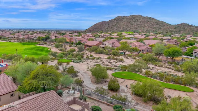 a living room with furniture and a wall painting
