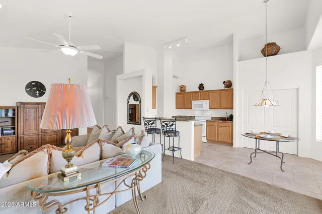 a kitchen with cabinets and chairs