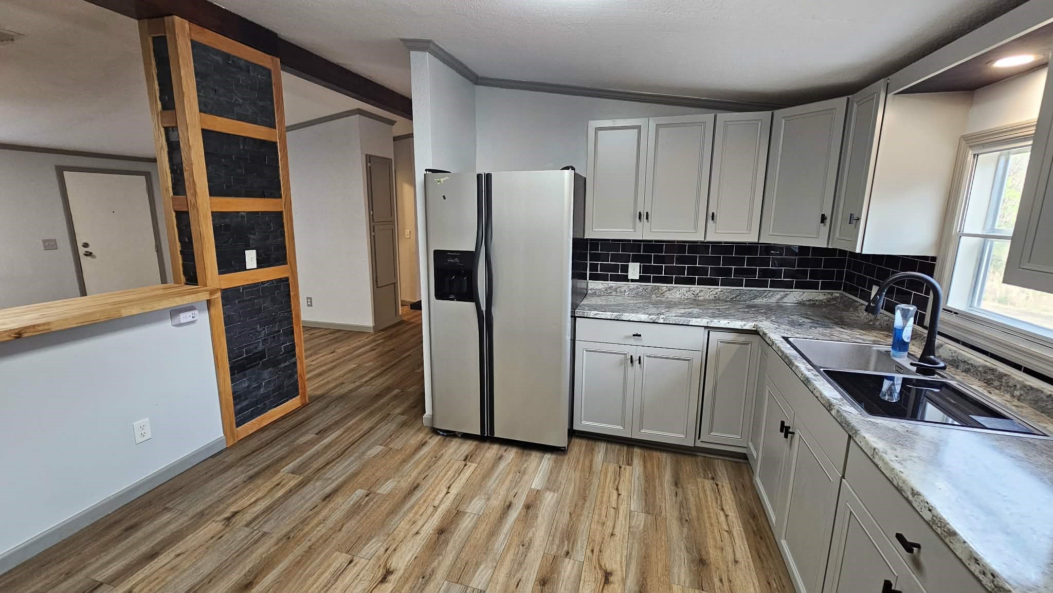 28183 Ramble Lane Hilliard, FL 32046 - Photo 12 of 34 a kitchen with cabinets appliances and a wooden floor