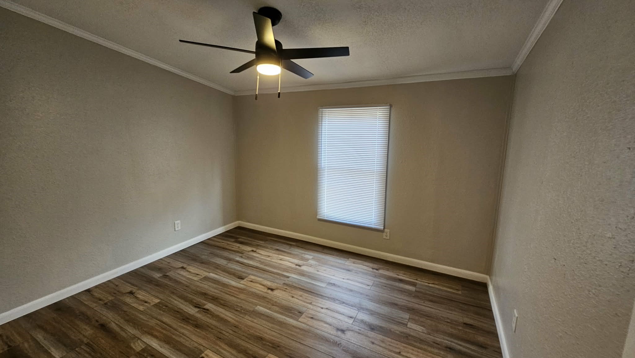 28183 Ramble Lane Hilliard, FL 32046 - Photo 15 of 34 an empty room with wooden floor chandelier fan and windows