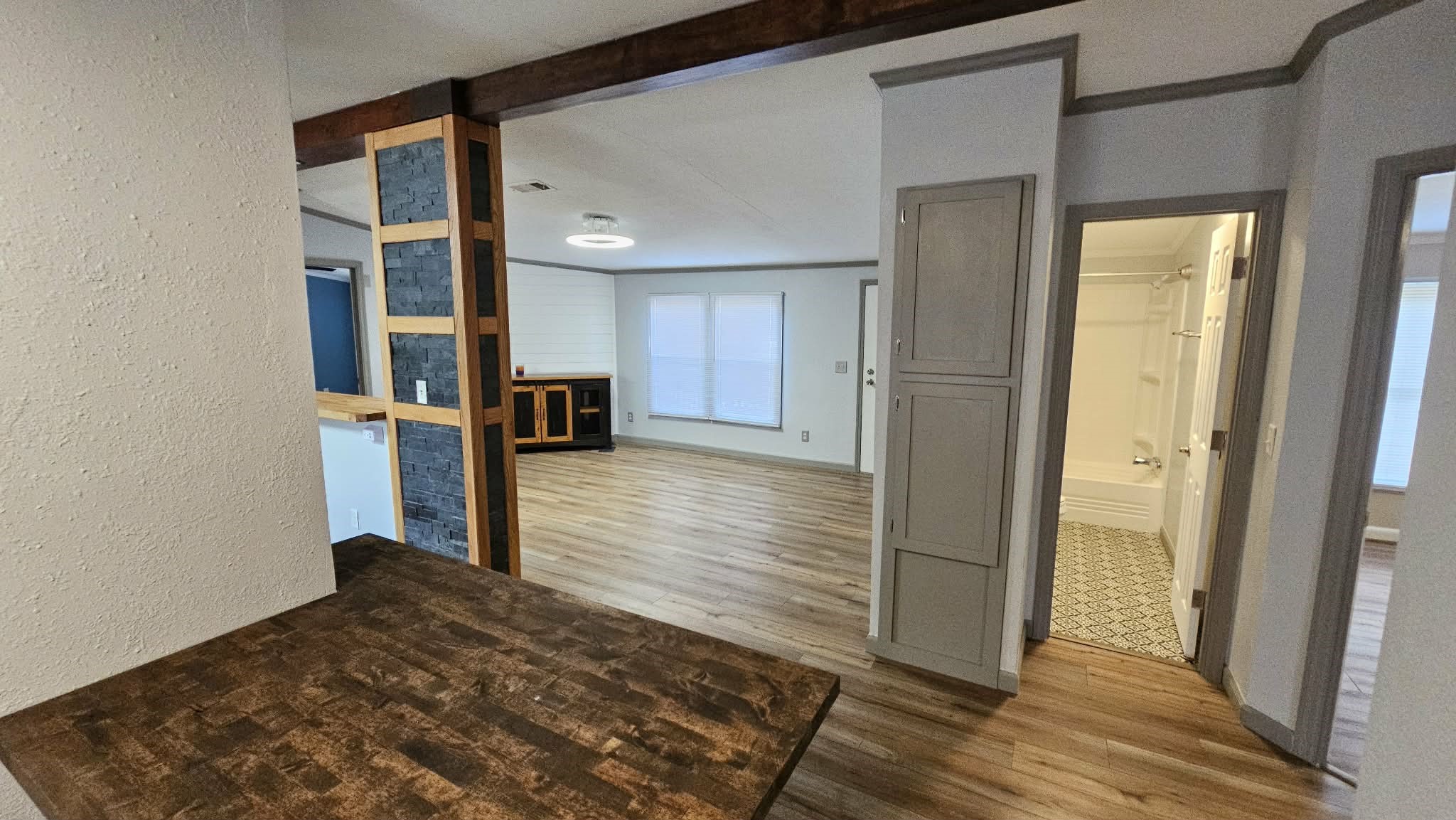 28183 Ramble Lane Hilliard, FL 32046 - Photo 16 of 34 a view of a hallway with wooden floor and staircase