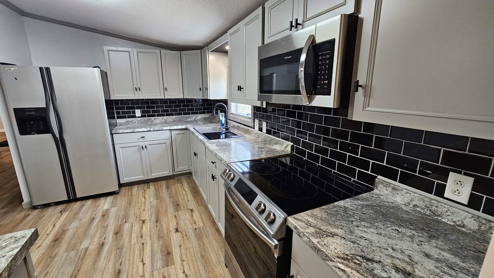 28183 Ramble Lane Hilliard, FL 32046 - Photo 17 of 34 a kitchen with granite countertop a stove and a microwave