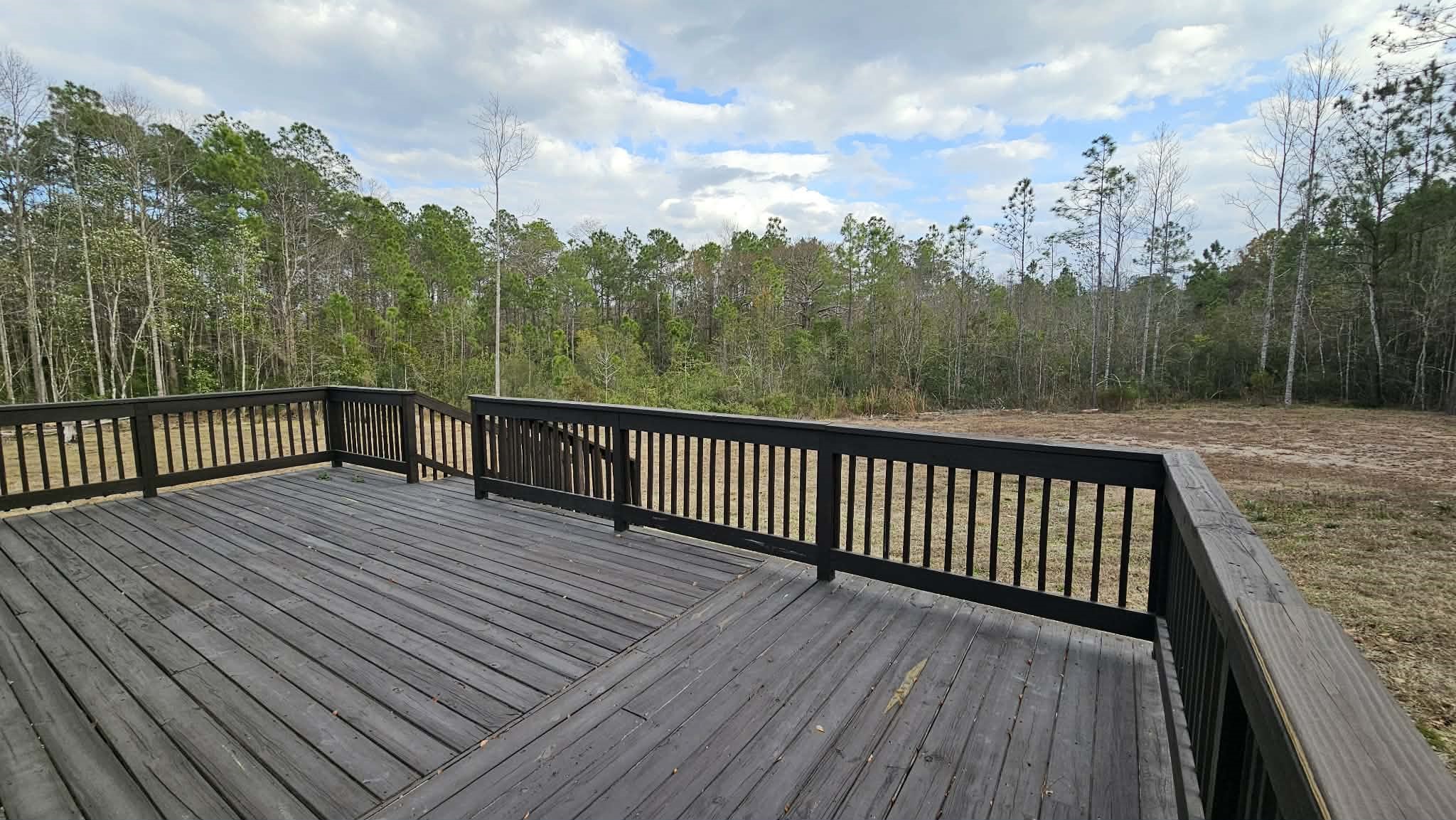 28183 Ramble Lane Hilliard, FL 32046 - Photo 25 of 34 a view of balcony with wooden floor and fence