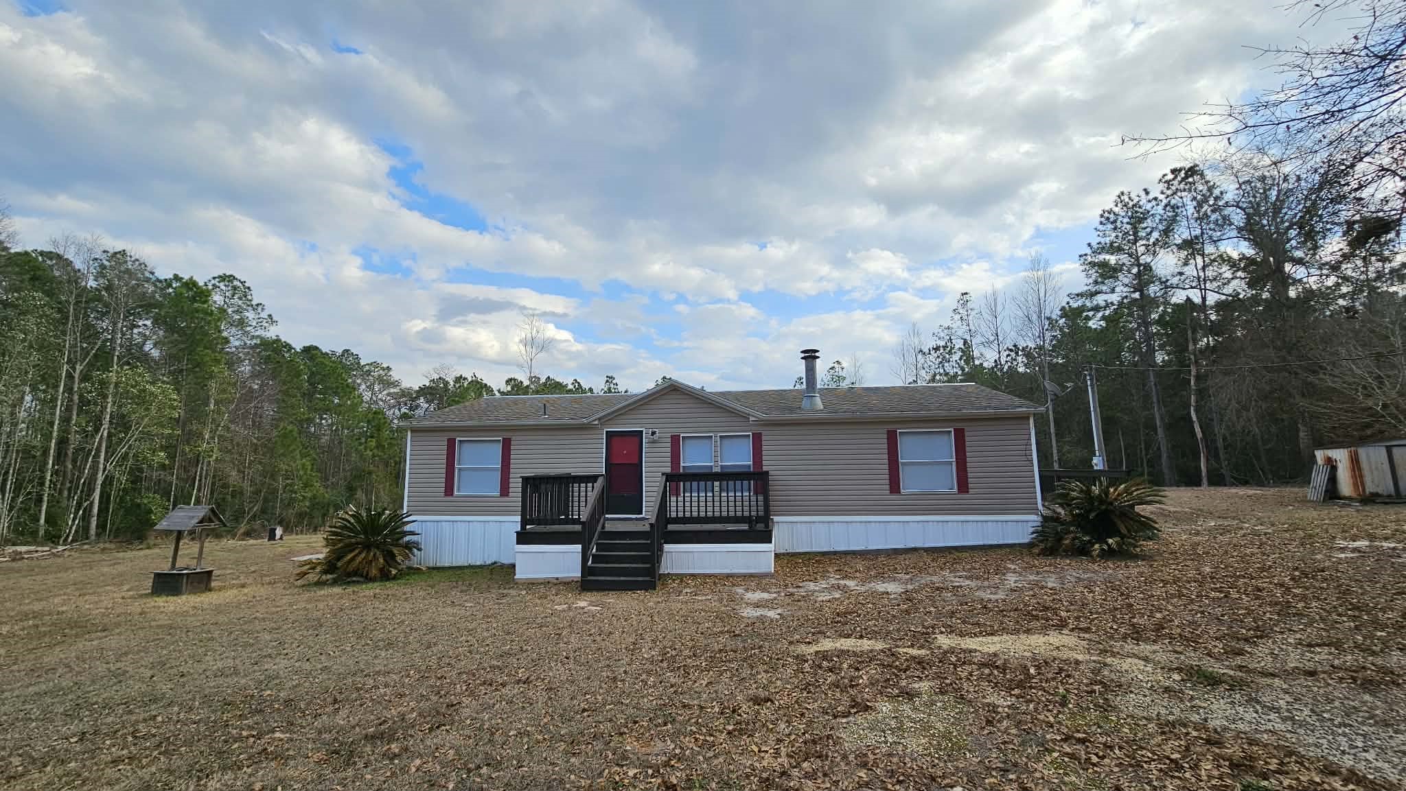 28183 Ramble Lane Hilliard, FL 32046 - Photo 32 of 34 a view of a house with a backyard and trees