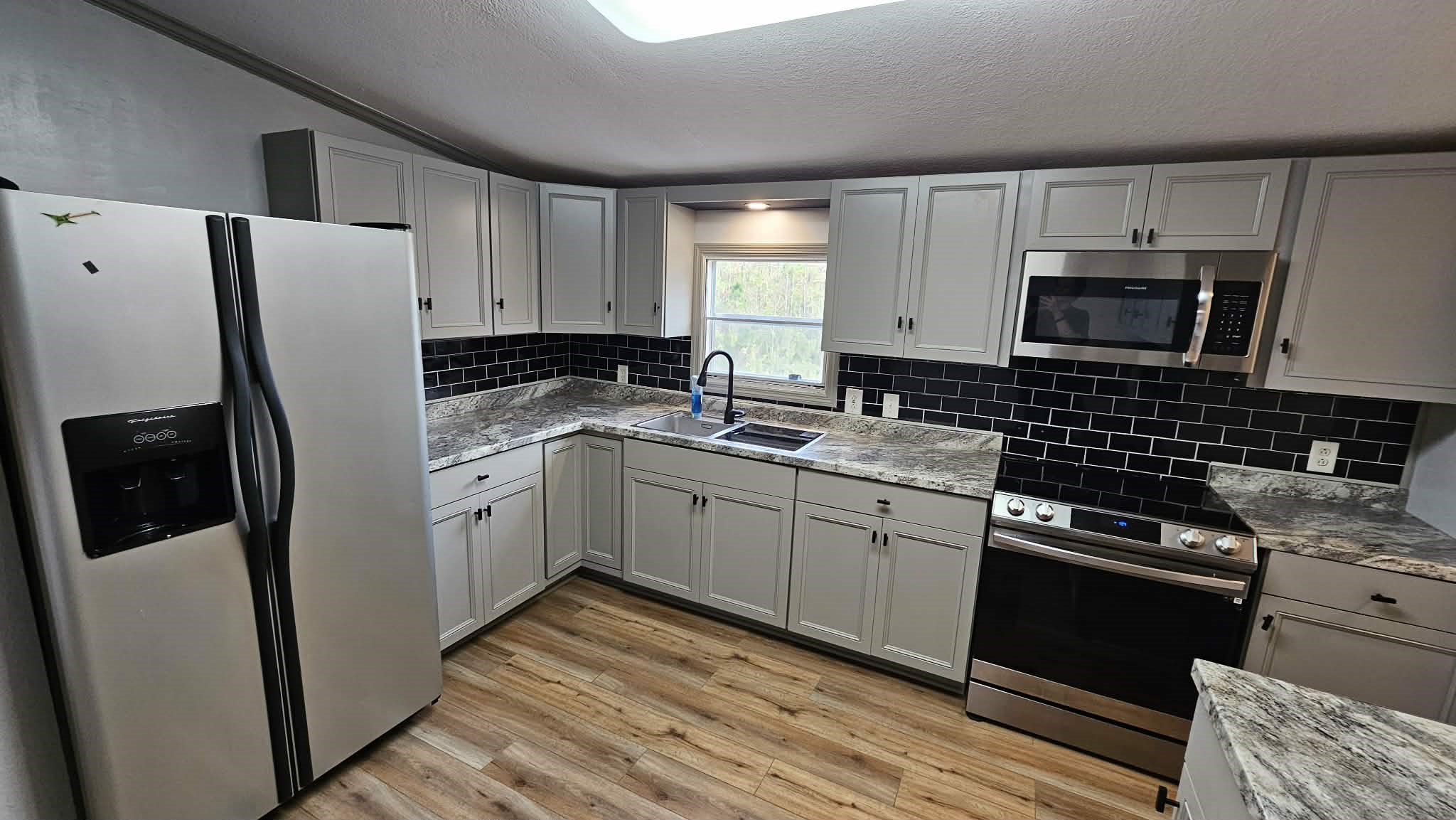 28183 Ramble Lane Hilliard, FL 32046 - Photo 6 of 34 a kitchen with a refrigerator stove and microwave