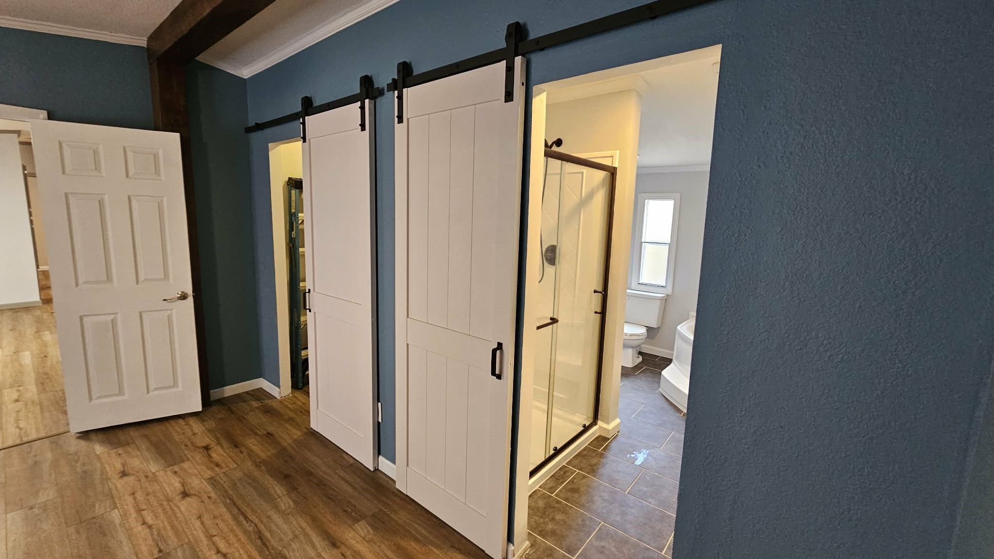 28183 Ramble Lane Hilliard, FL 32046 - Photo 10 of 34 a view of a bathroom with a glass door shower and wooden floor