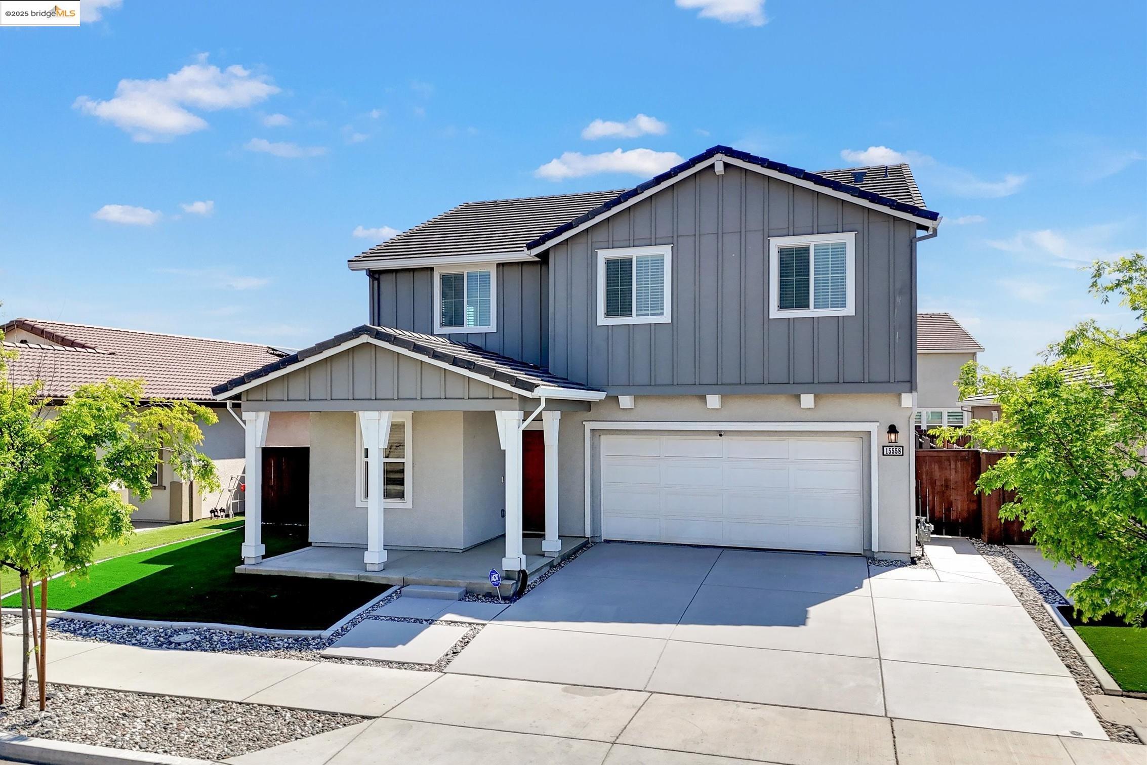 a front view of a house with a yard and garage