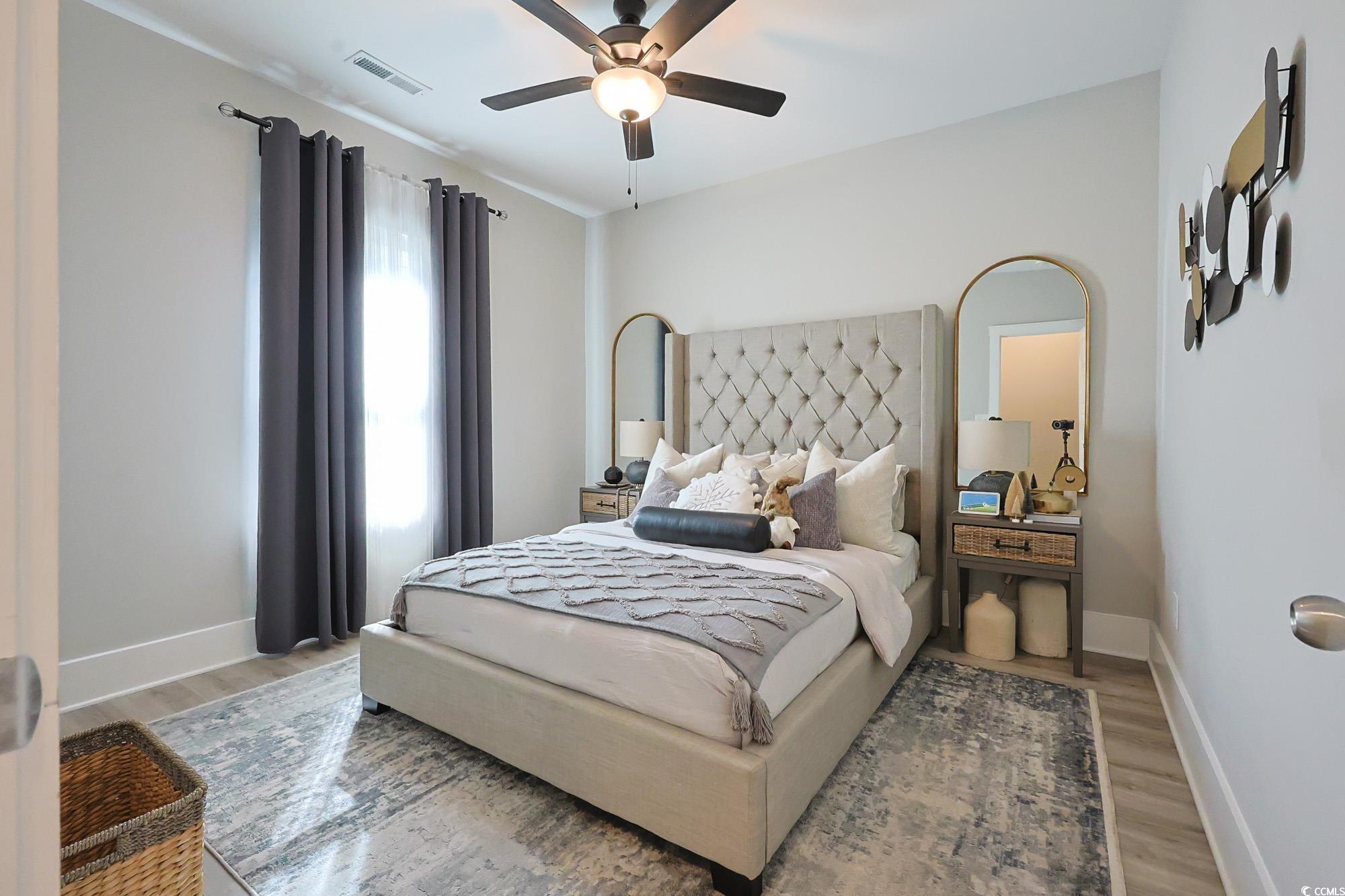 669 Pacific Commons Drive Surfside Beach, SC 29575 - Photo 17 of 36 Bedroom featuring a ceiling fan and wood finished floors