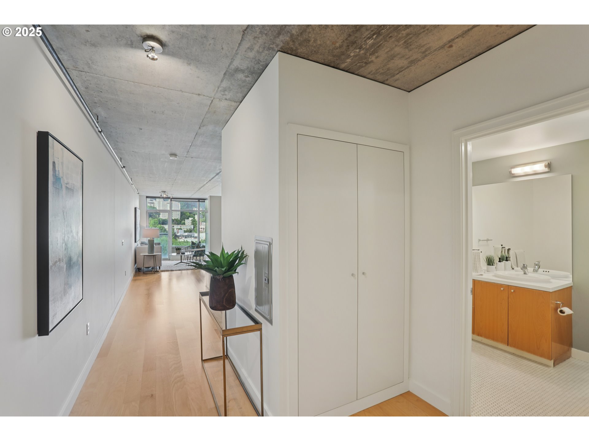 1926 West Burnside Street, Unit 912 Portland, OR 97209 - Photo 12 of 19 a hallway with a dining table and chairs