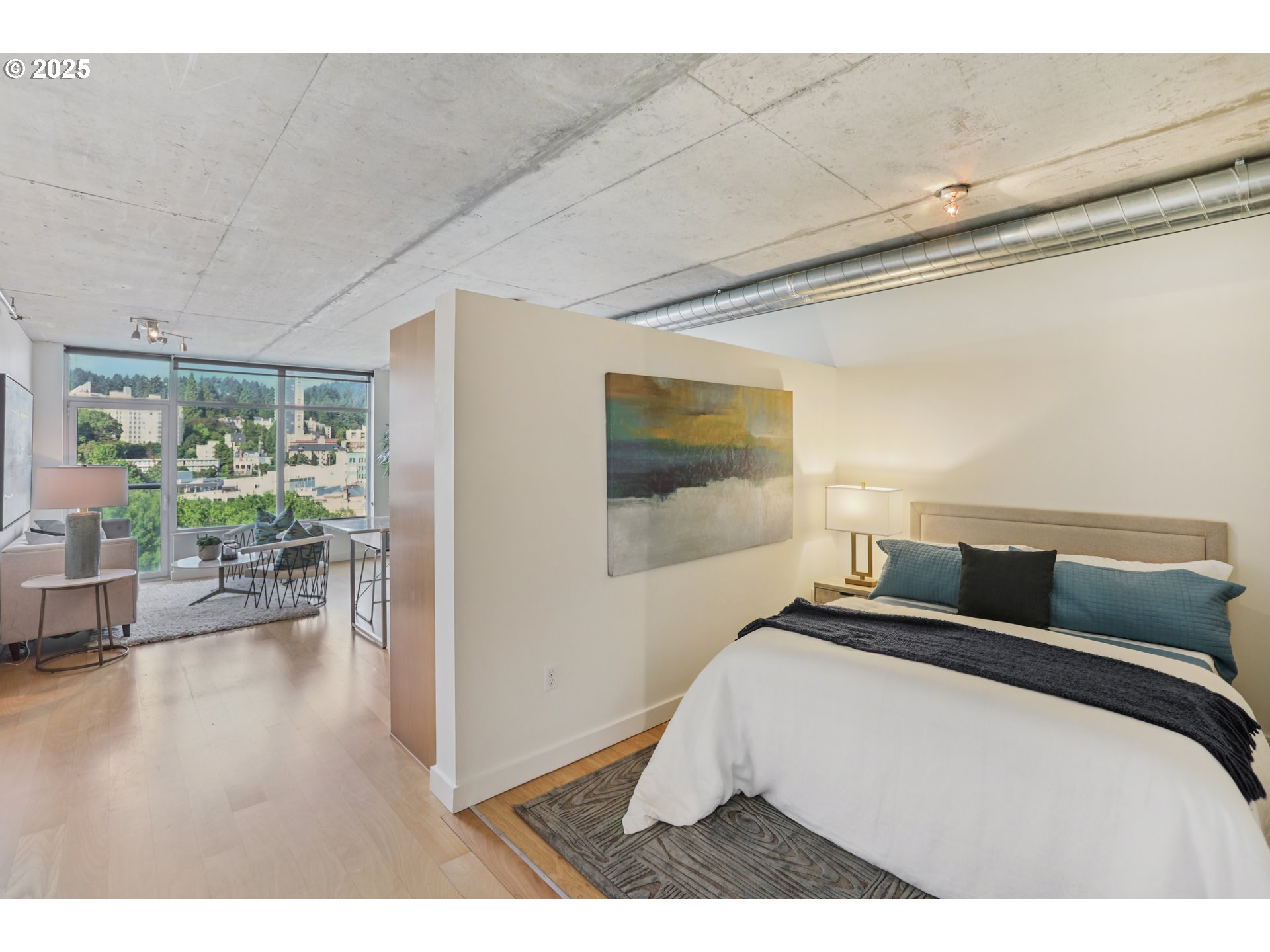 1926 West Burnside Street, Unit 912 Portland, OR 97209 - Photo 13 of 19 a bedroom with a bed and wooden floor