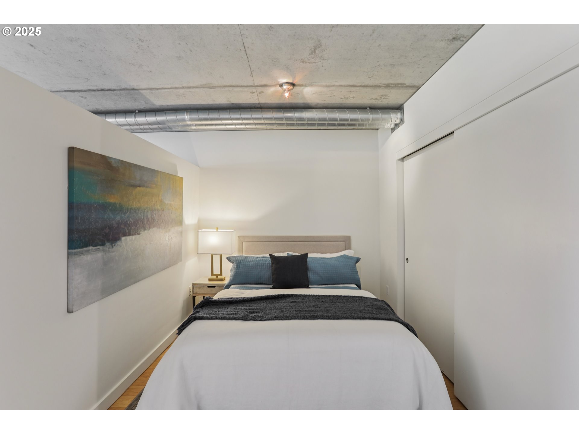 1926 West Burnside Street, Unit 912 Portland, OR 97209 - Photo 14 of 19 a bedroom with a bed and glass wall