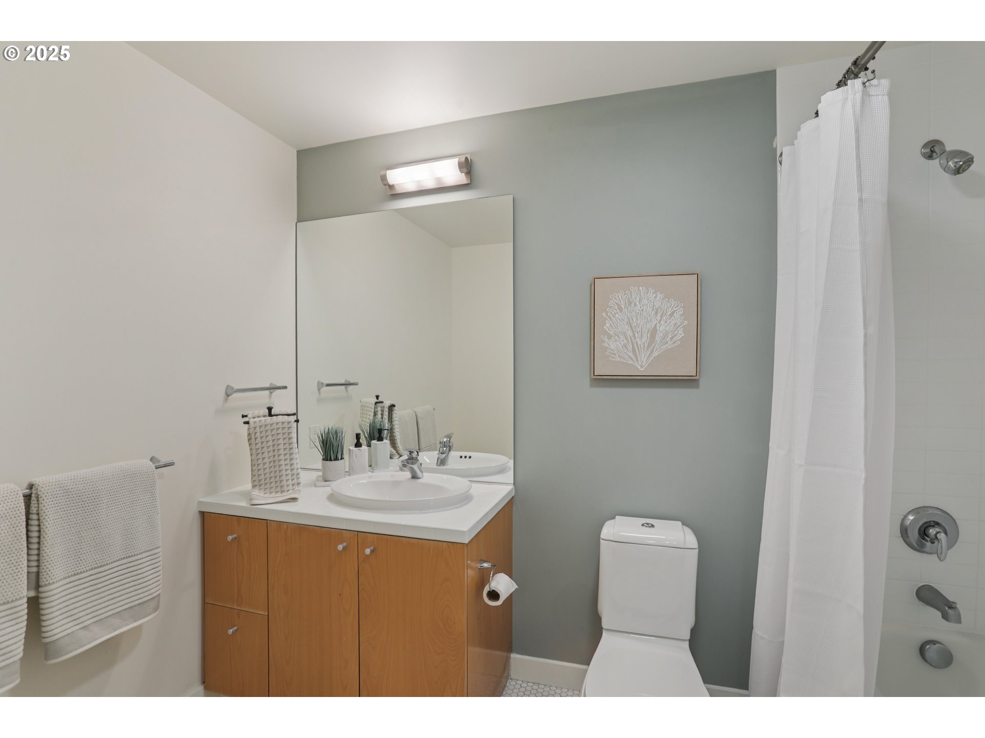 1926 West Burnside Street, Unit 912 Portland, OR 97209 - Photo 15 of 19 a bathroom with a sink vanity and mirror