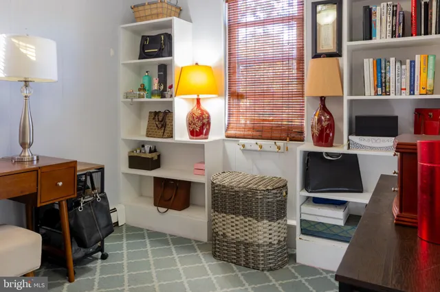 a living room with furniture and a lamp