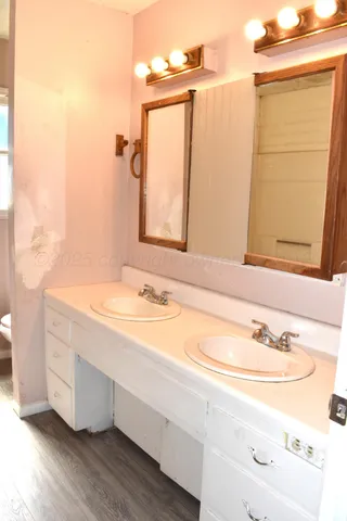 a bathroom with a double vanity sink and a mirror
