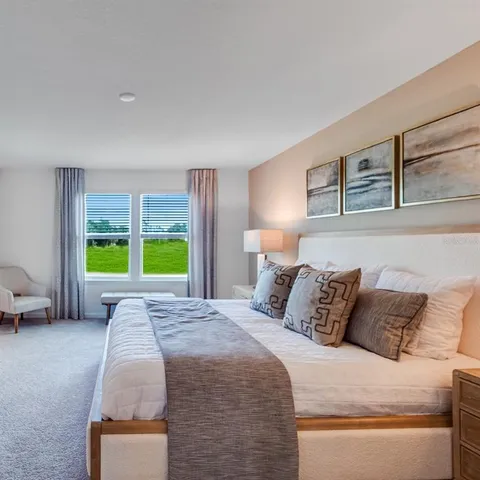 a bedroom with a bed and lamp