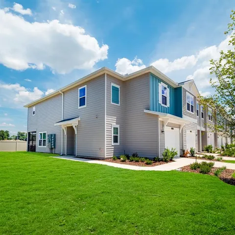 a front view of house with yard and green space