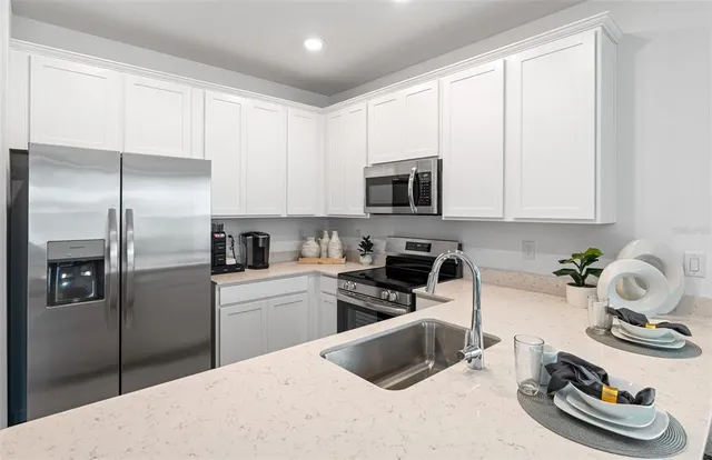 a view of a workspace with furniture and a refrigerator