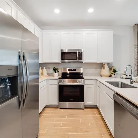 a view of a dining room with furniture and windows
