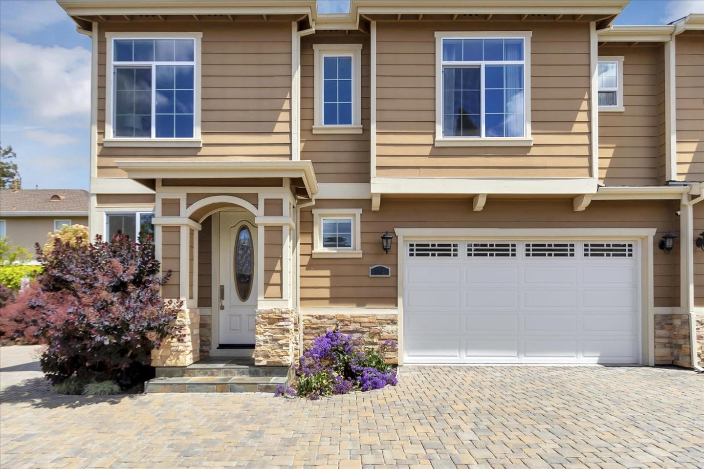 a front view of a house with a garden