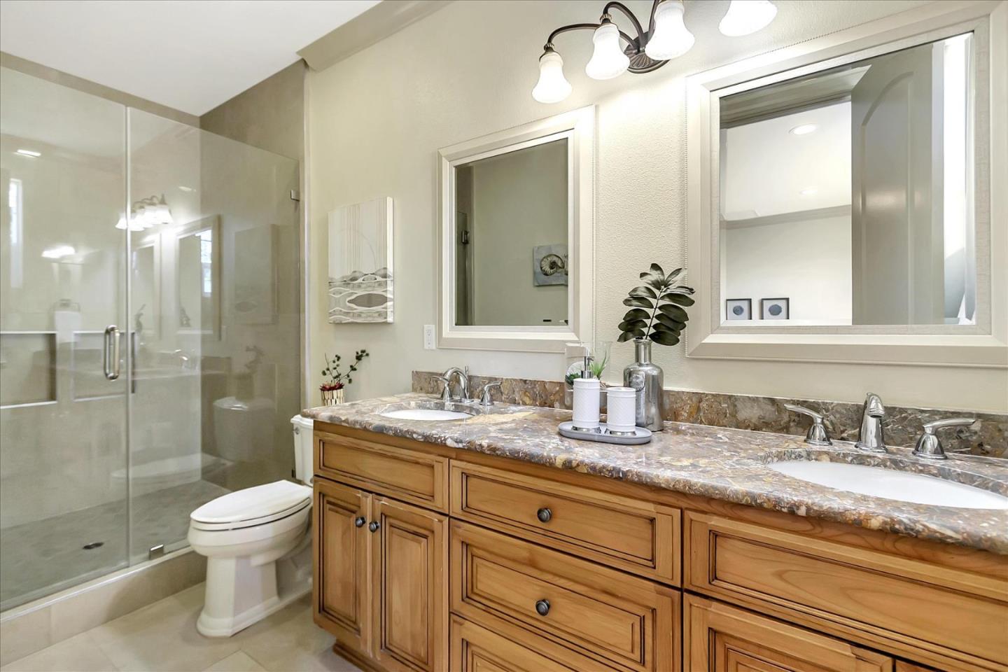 184 Redding Road Campbell, CA 95008 - Photo 23 of 34 a bathroom with a granite countertop sink toilet a large mirror a shower and a bathtub