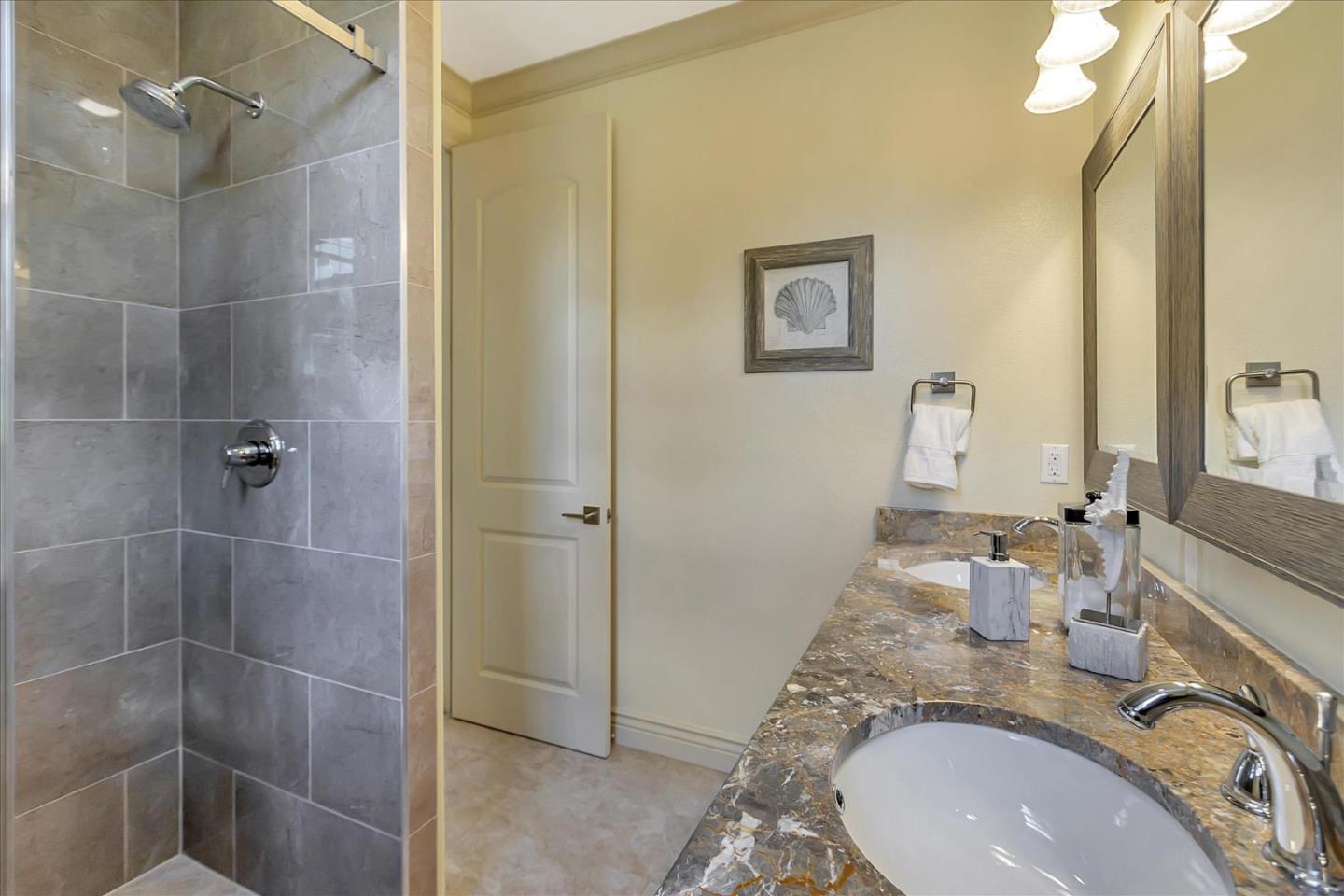 184 Redding Road Campbell, CA 95008 - Photo 26 of 34 a bathroom with a granite countertop sink a mirror and shower