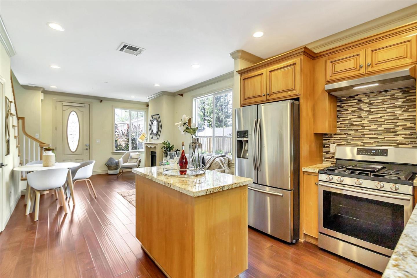 184 Redding Road Campbell, CA 95008 - Photo 9 of 34 a kitchen with a refrigerator a stove cabinets dining table and chairs