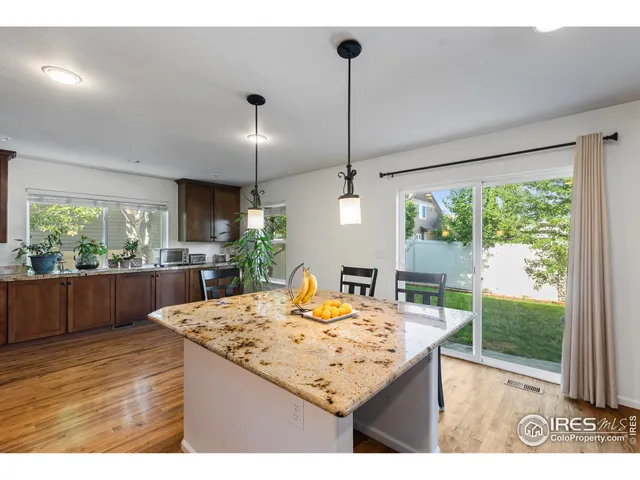 a kitchen with kitchen island a counter top space appliances and cabinets
