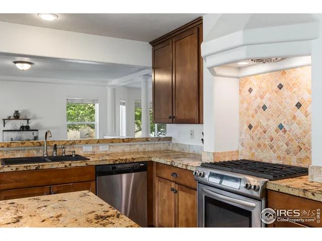 a kitchen with stainless steel appliances granite countertop a stove and a sink
