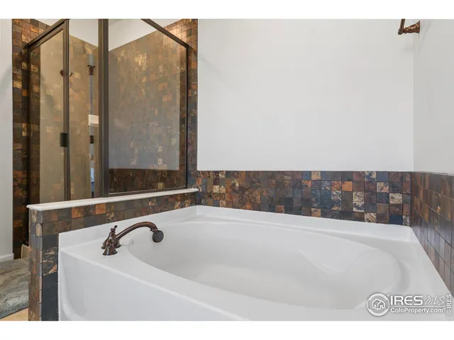 a bathroom with a bathtub and shower