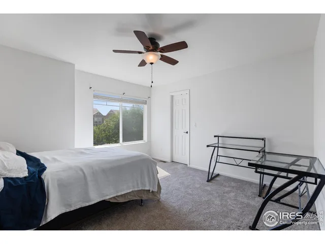 a bedroom with a bed a desk and chair