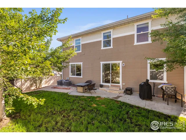 a view of a backyard with table and chairs and potted plants