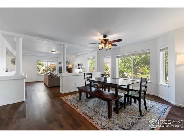 a view of a dining room with furniture window and wooden floor