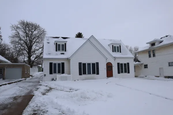 a view of a white house with a yard