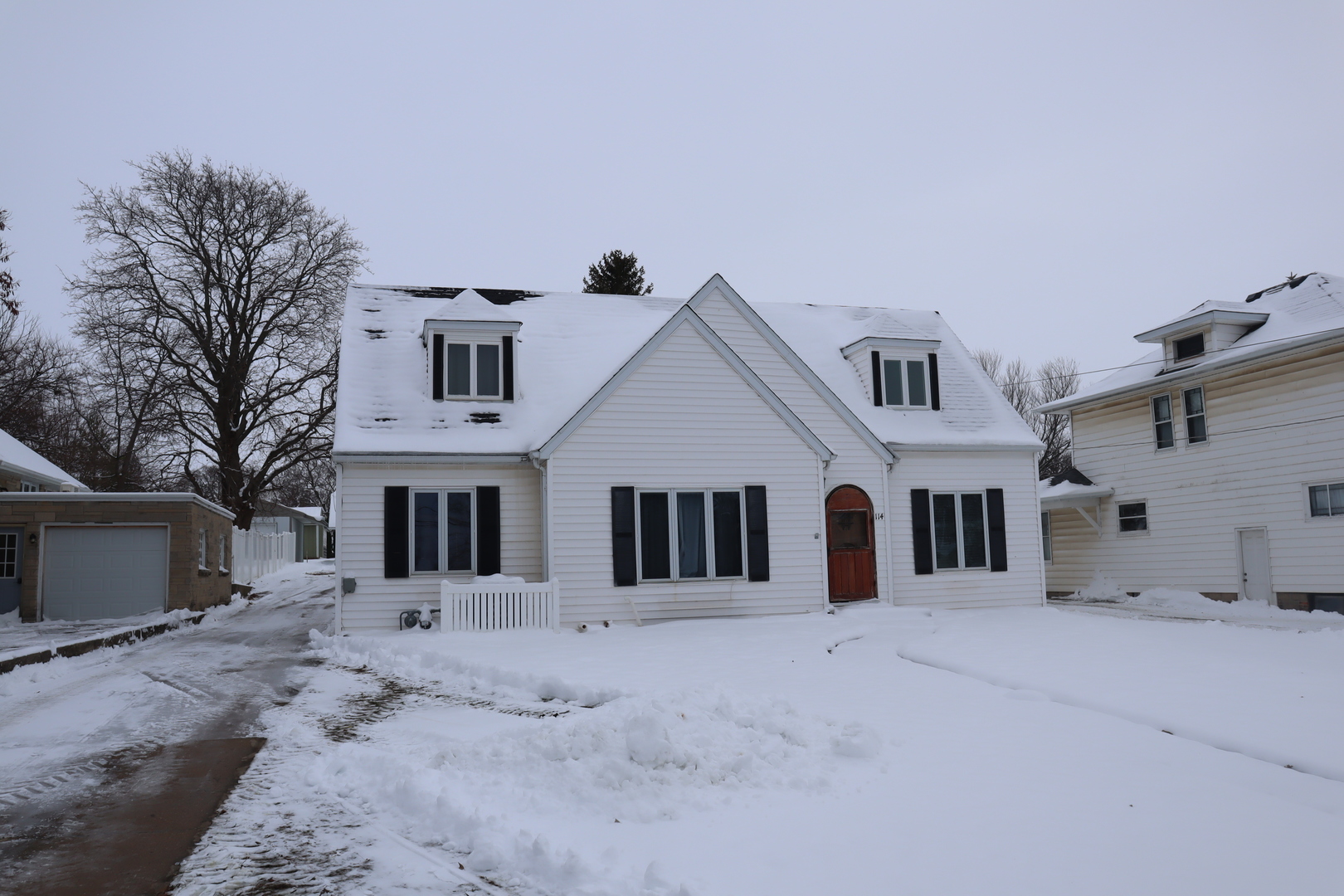 a view of a white house with a yard