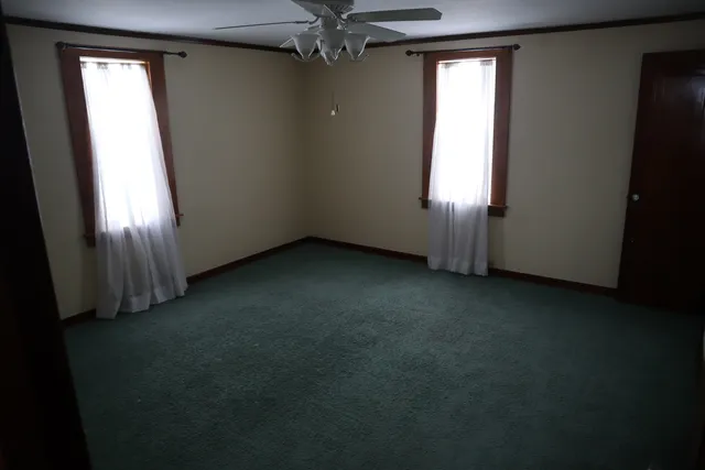 an empty room with windows and closet